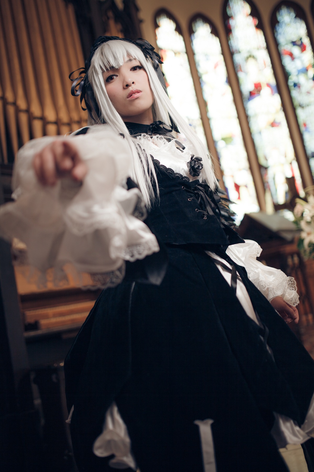 1girl 3d blurry blurry_background blurry_foreground depth_of_field dress gothic_lolita indoors lips long_hair long_sleeves looking_at_viewer photo solo standing suigintou white_hair