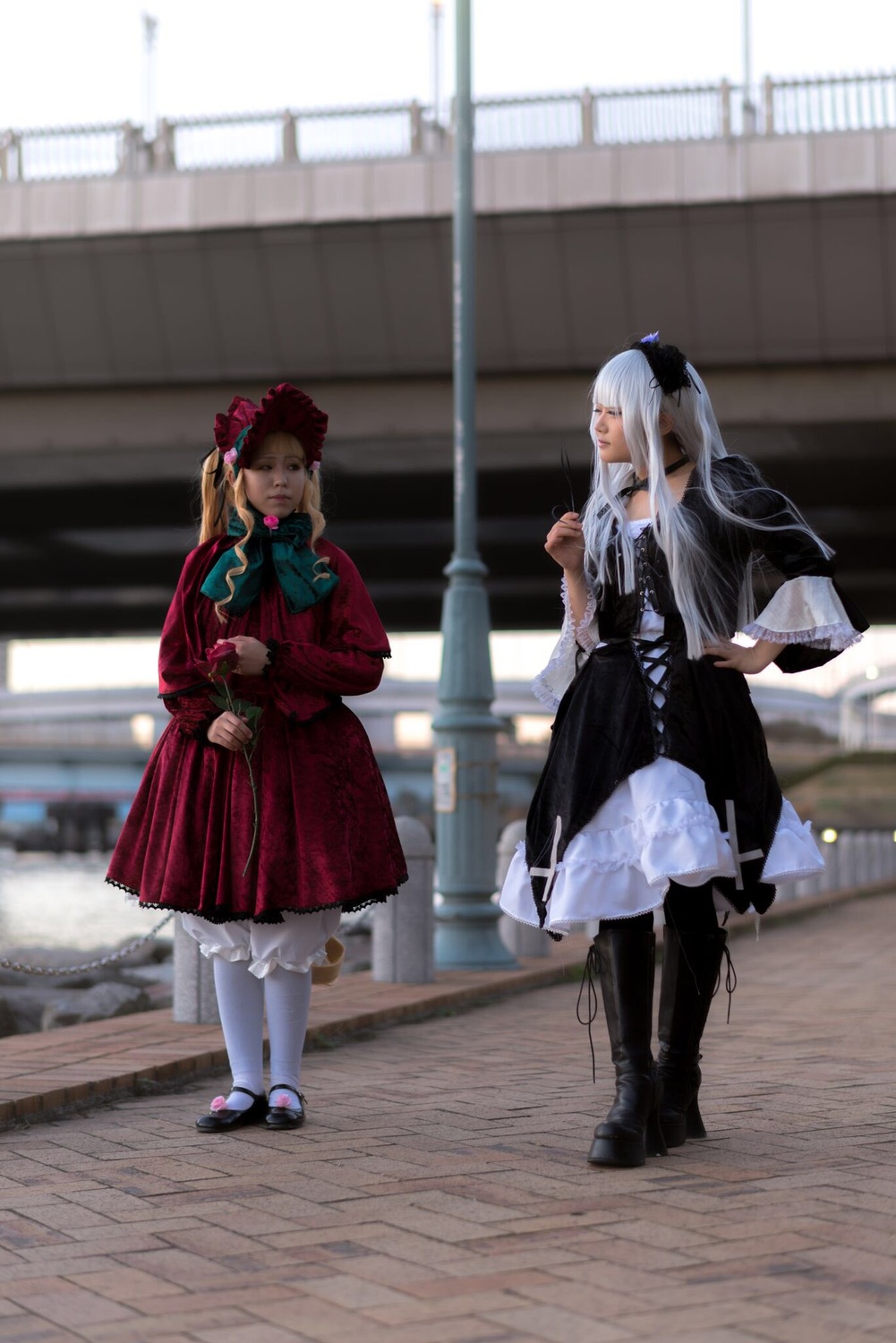 2girls black_footwear blonde_hair blurry blurry_background depth_of_field dress hair_ornament lolita_fashion long_hair long_sleeves multiple_cosplay multiple_girls pantyhose standing tagme twintails white_legwear wide_sleeves