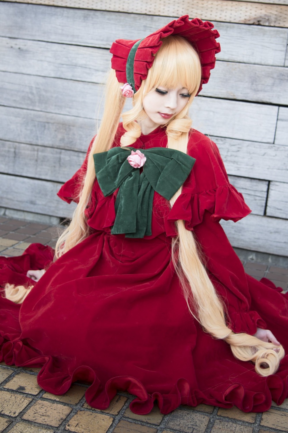 1girl blonde_hair blue_eyes bonnet bow capelet dress flower long_hair on_floor pantyhose red_dress shinku sitting solo tile_floor tiles