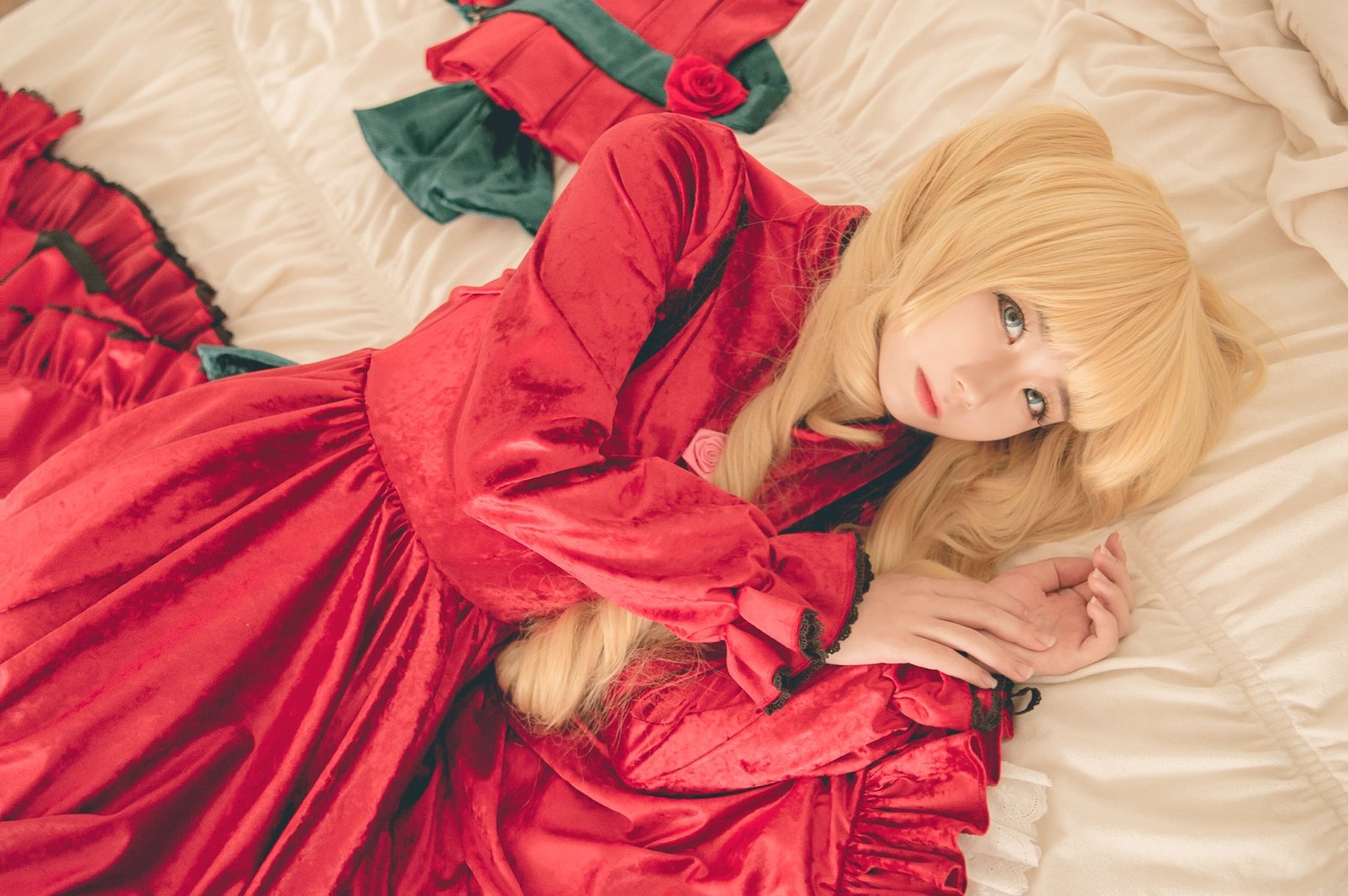 1girl blonde_hair dress flower frills lips long_hair looking_at_viewer lying on_bed on_side pillow red_dress rose shinku solo