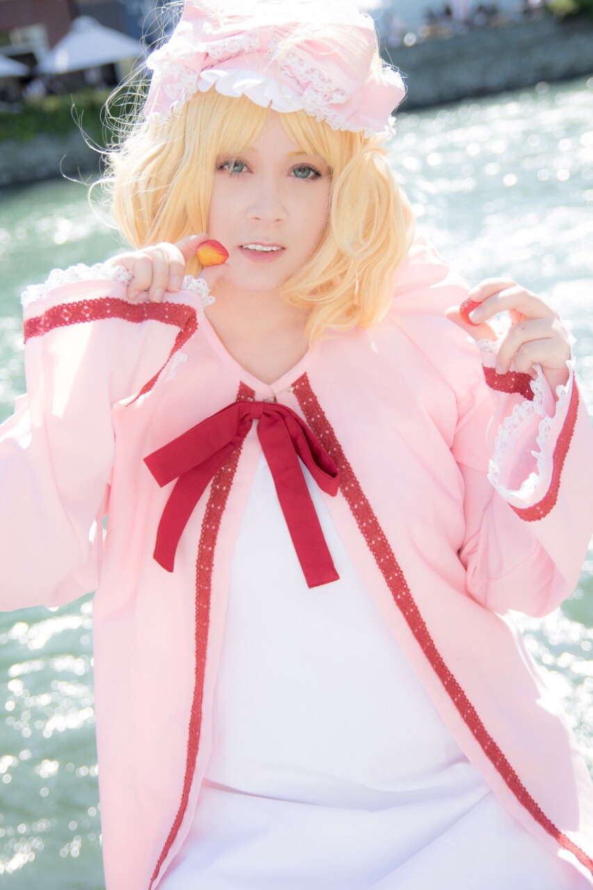 1girl blonde_hair blue_eyes blurry blurry_background depth_of_field dress food fruit hat hinaichigo holding_food neck_ribbon outdoors photo realistic ribbon short_hair smile solo striped