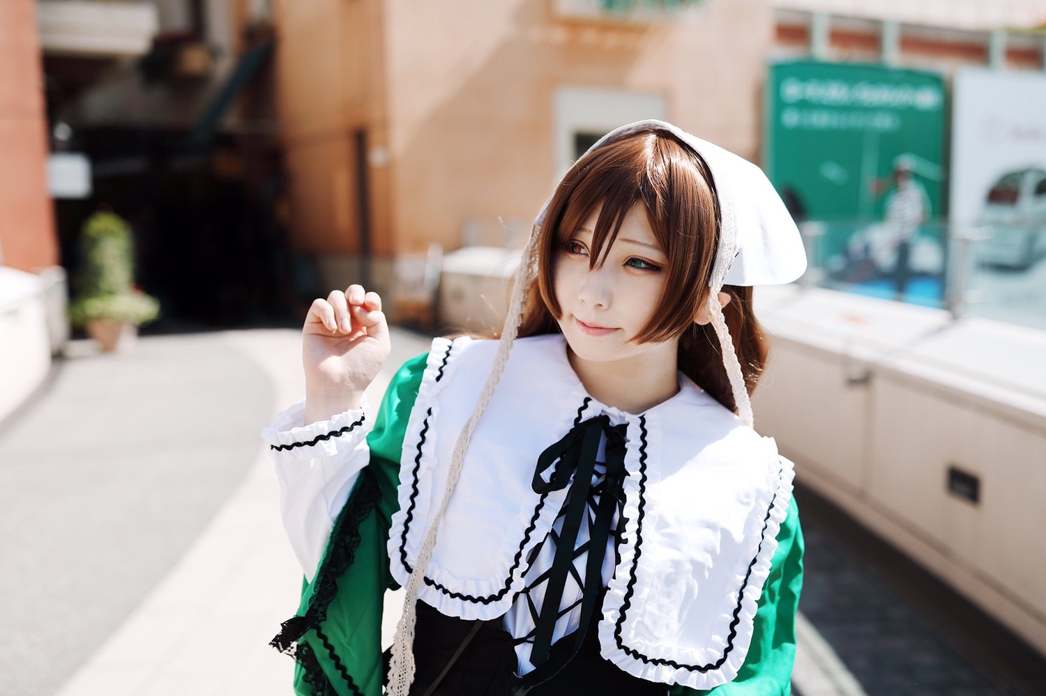 1girl 3d blurry blurry_background blurry_foreground brown_hair depth_of_field dress green_dress hat indoors long_sleeves looking_at_viewer photo ribbon solo suiseiseki