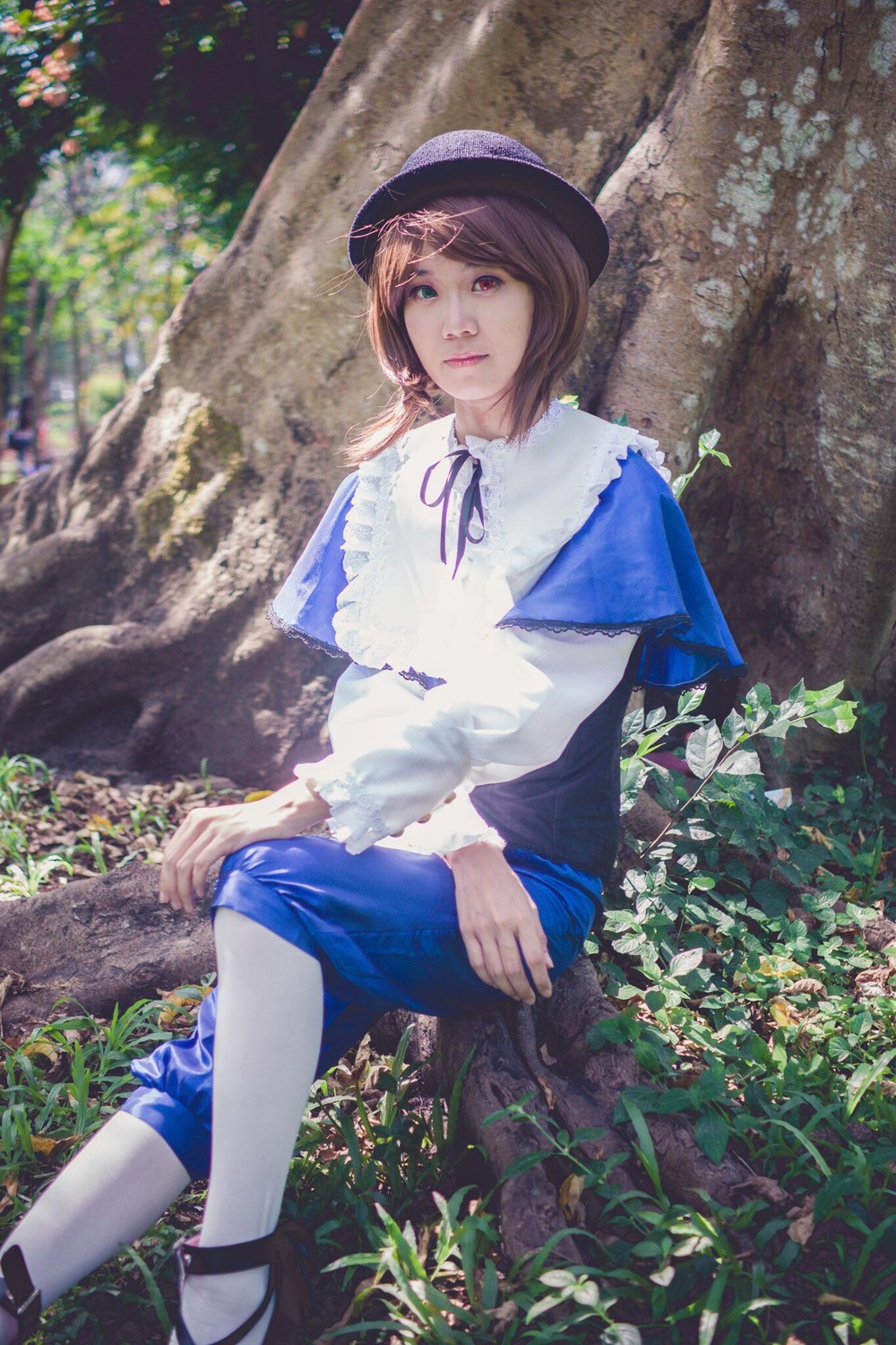 1girl blue_skirt brown_hair capelet grass hat lips nature outdoors realistic ribbon short_hair sitting skirt solo souseiseki sunlight