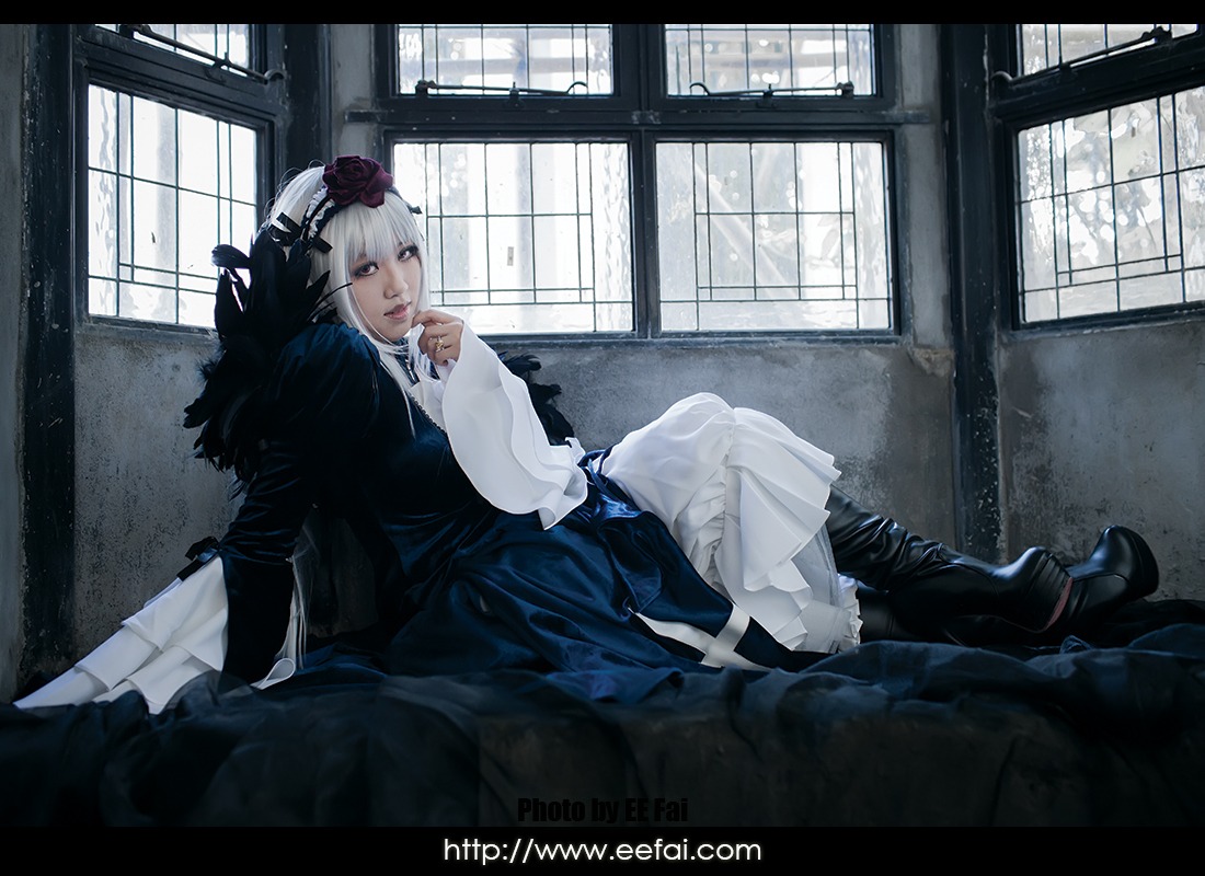 1girl auto_tagged black_border curtains dress flower frills gothic_lolita hair_ornament hat indoors letterboxed lolita_fashion long_sleeves sitting solo suigintou window