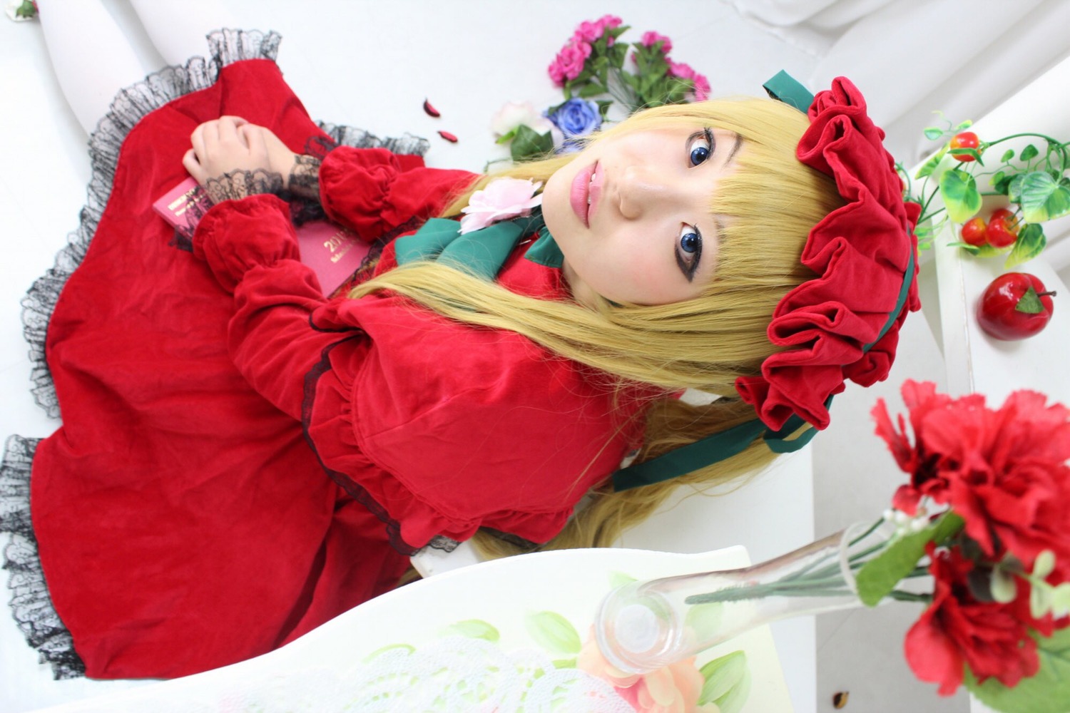 1girl blonde_hair blue_eyes bonnet capelet dress flower frills lips long_hair looking_at_viewer pantyhose realistic red_dress red_flower red_rose rose shinku sitting solo