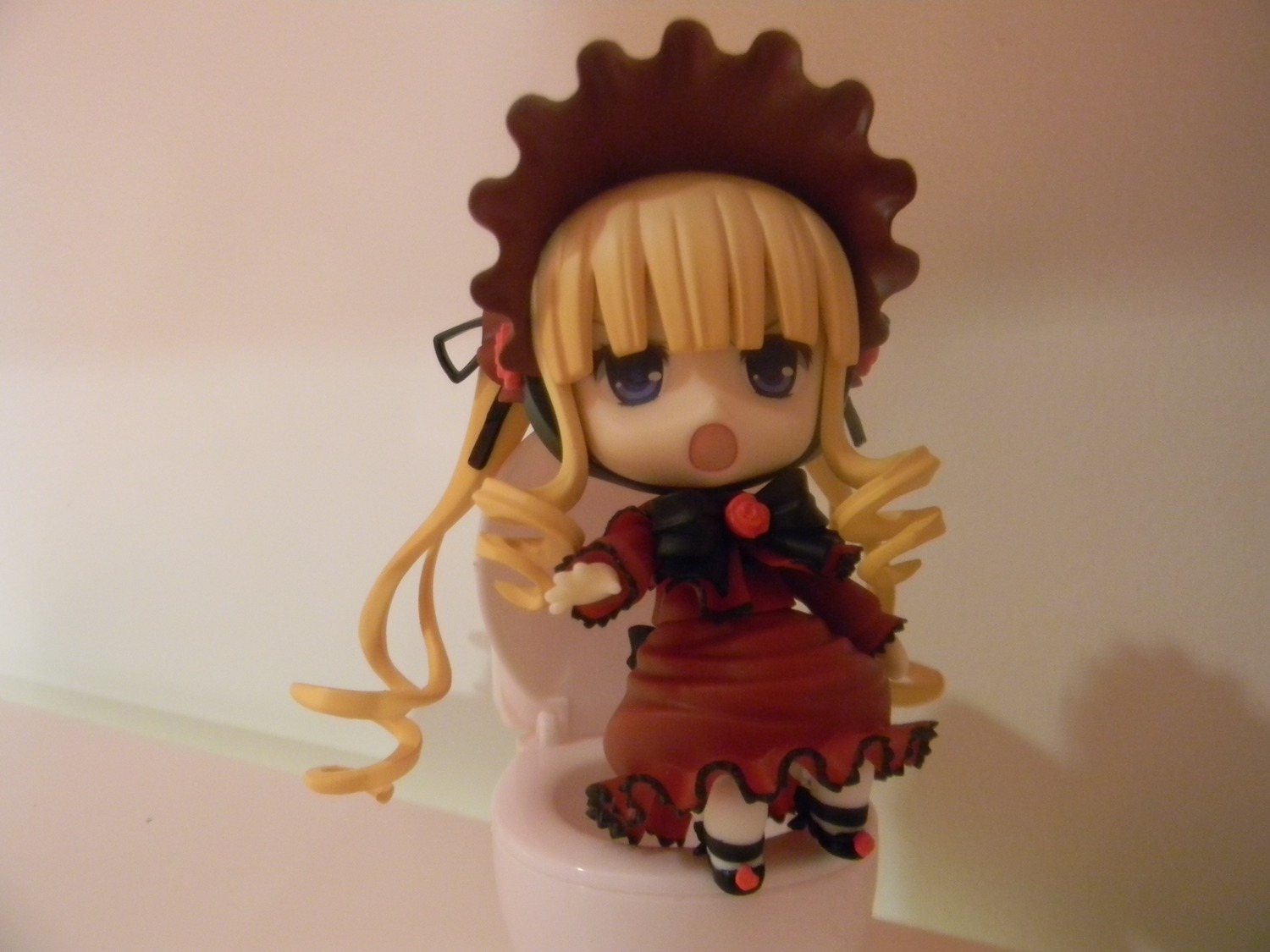 1girl blonde_hair blue_eyes bonnet bow chibi doll dress drill_hair long_hair long_sleeves looking_at_viewer open_mouth photo red_dress shinku shoes solo standing