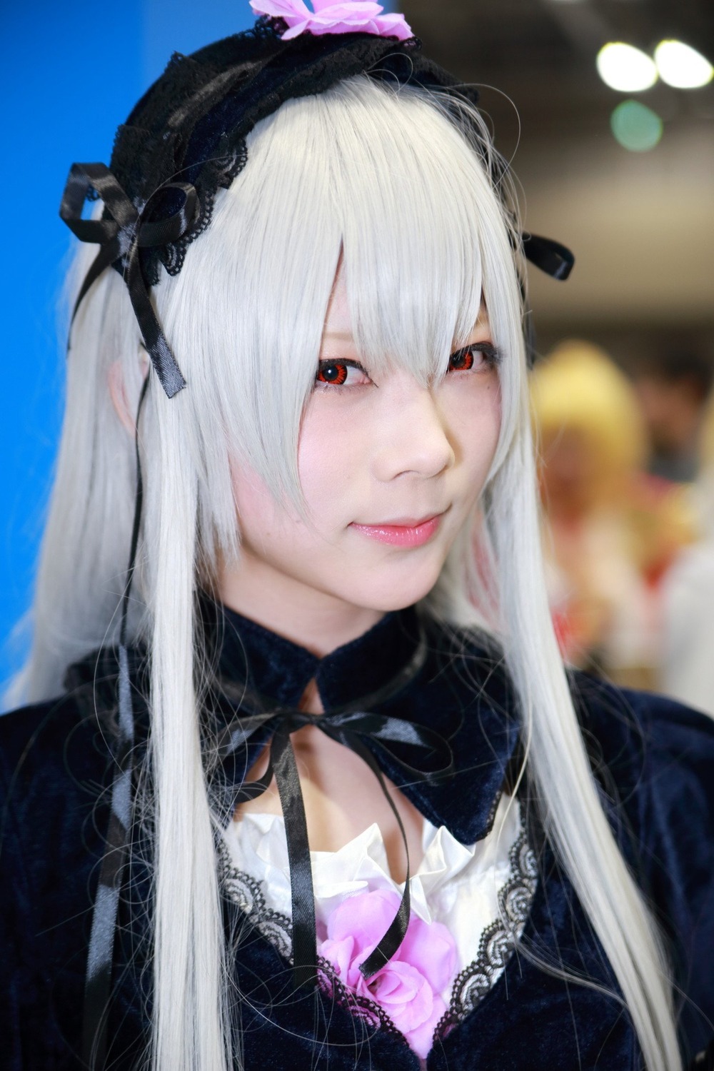 1girl bangs black_choker blurry blurry_background choker closed_mouth depth_of_field dress hairband lace lips lolita_hairband long_hair photo portrait red_eyes ribbon silver_hair solo suigintou