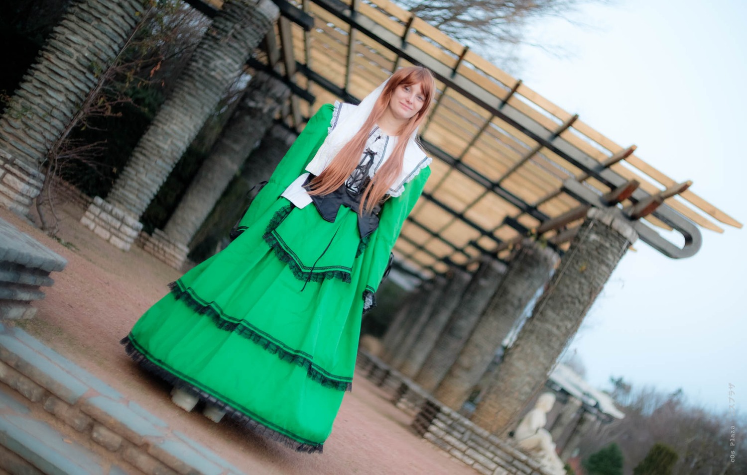 1girl blurry brown_hair building day dress green_dress long_hair long_skirt outdoors sky solo standing suiseiseki