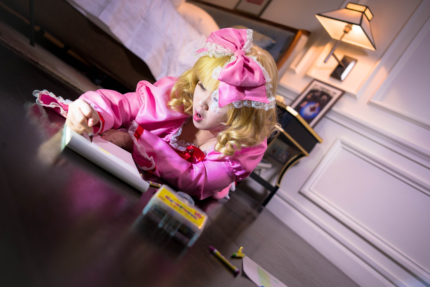 1girl blonde_hair blurry bow closed_eyes depth_of_field dress hair_bow hinaichigo indoors lips photo pink_bow pink_dress sitting solo