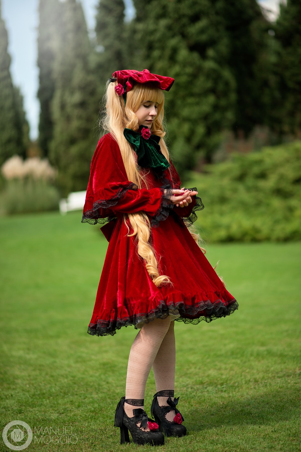 1girl black_footwear blonde_hair blurry blurry_background bonnet bow capelet depth_of_field dress flower full_body long_hair long_sleeves outdoors red_dress rose shinku shoes solo standing