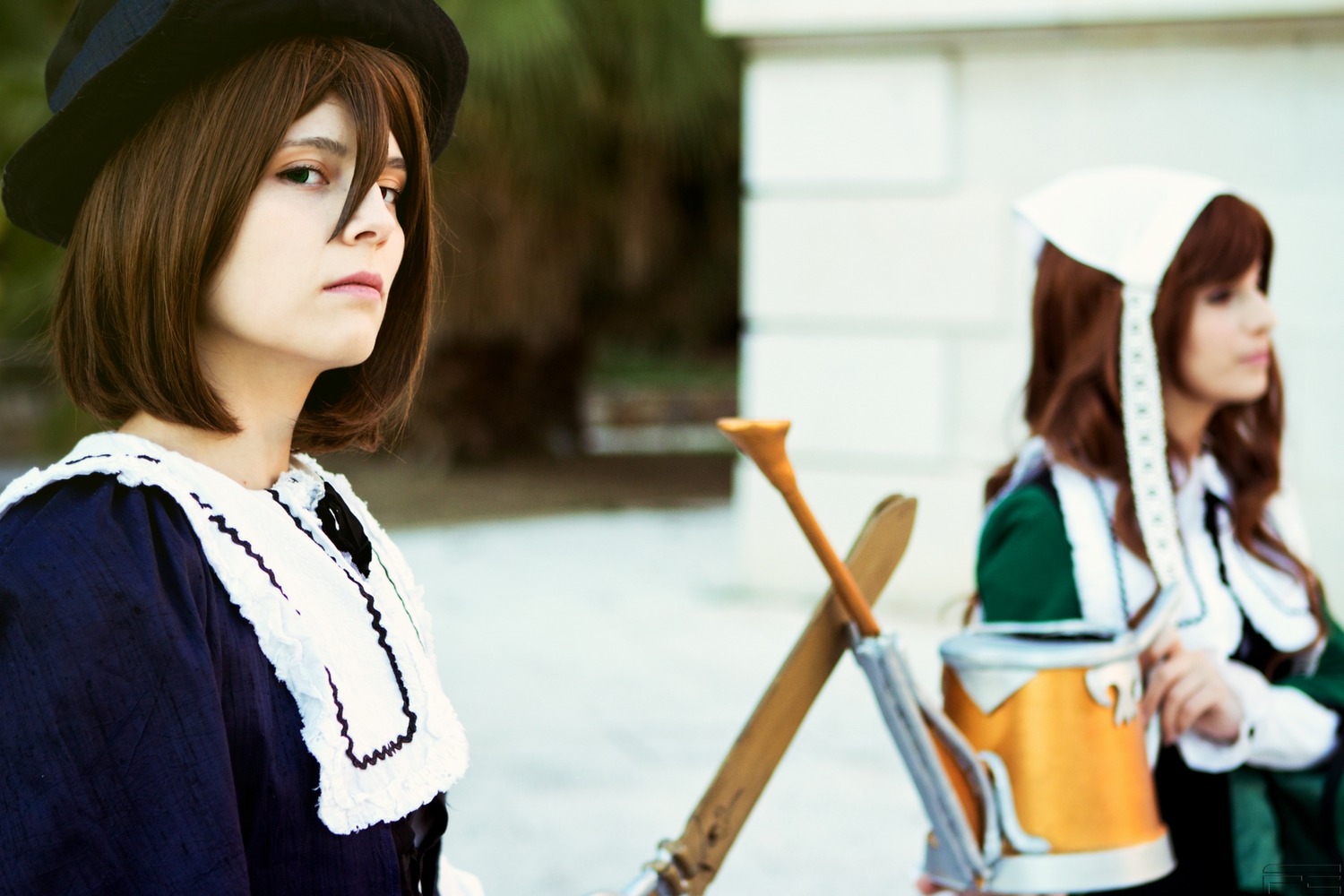 2girls blurry blurry_background brown_eyes brown_hair depth_of_field dress green_eyes hat multiple_cosplay multiple_girls short_hair tagme