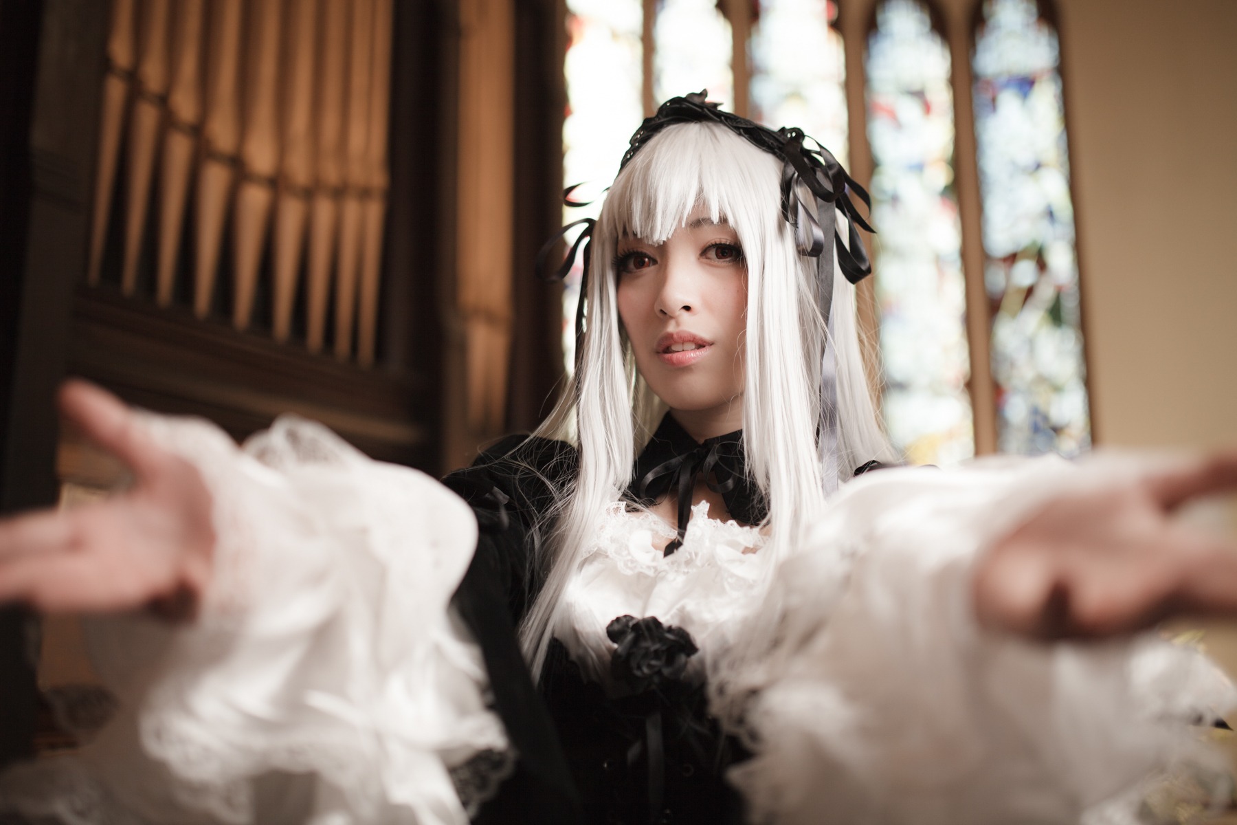 1girl 3d blurry blurry_background blurry_foreground depth_of_field dress foreshortening gothic_lolita hairband lips lolita_fashion lolita_hairband long_hair long_sleeves looking_at_viewer motion_blur outstretched_arm outstretched_hand photo reaching reaching_out solo suigintou white_hair