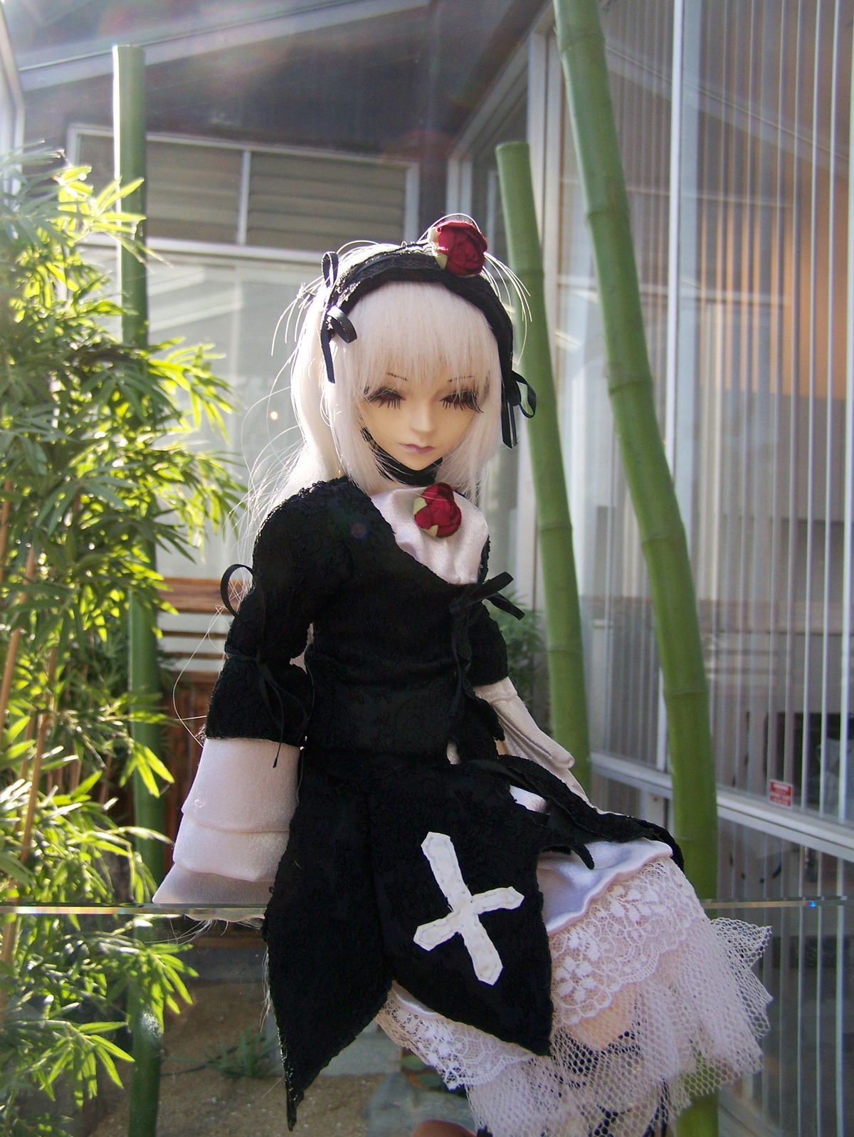 1girl black_dress doll dress flower frills gothic_lolita hairband lolita_fashion looking_at_viewer solo standing suigintou white_hair