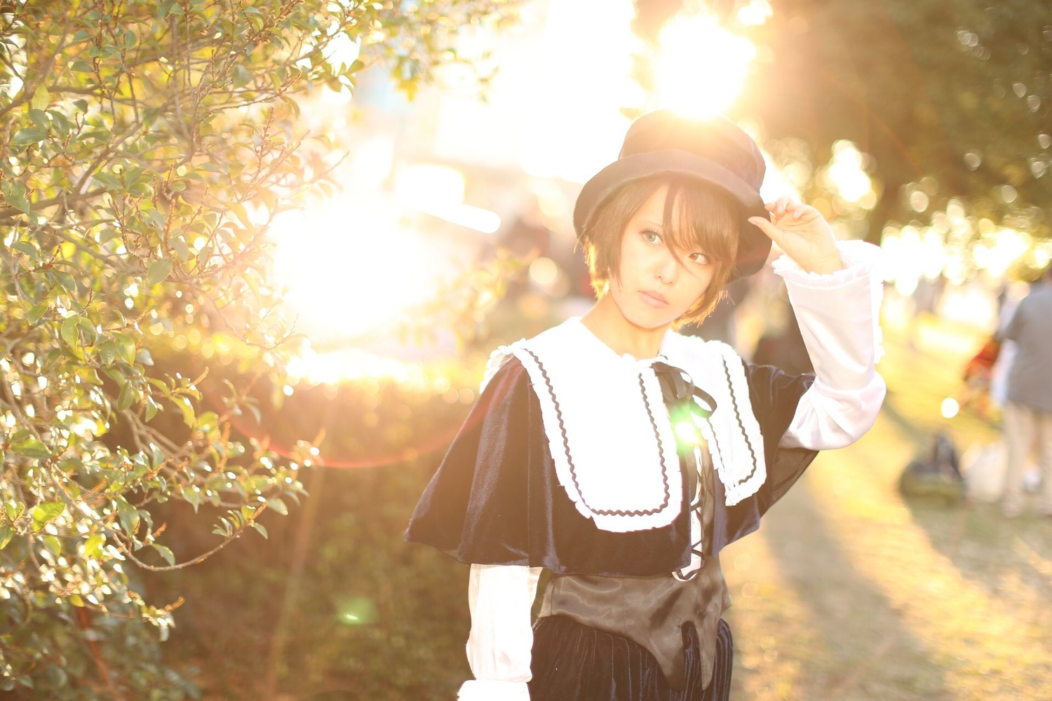 1girl blurry brown_hair capelet earrings hat jewelry looking_at_viewer outdoors solo souseiseki