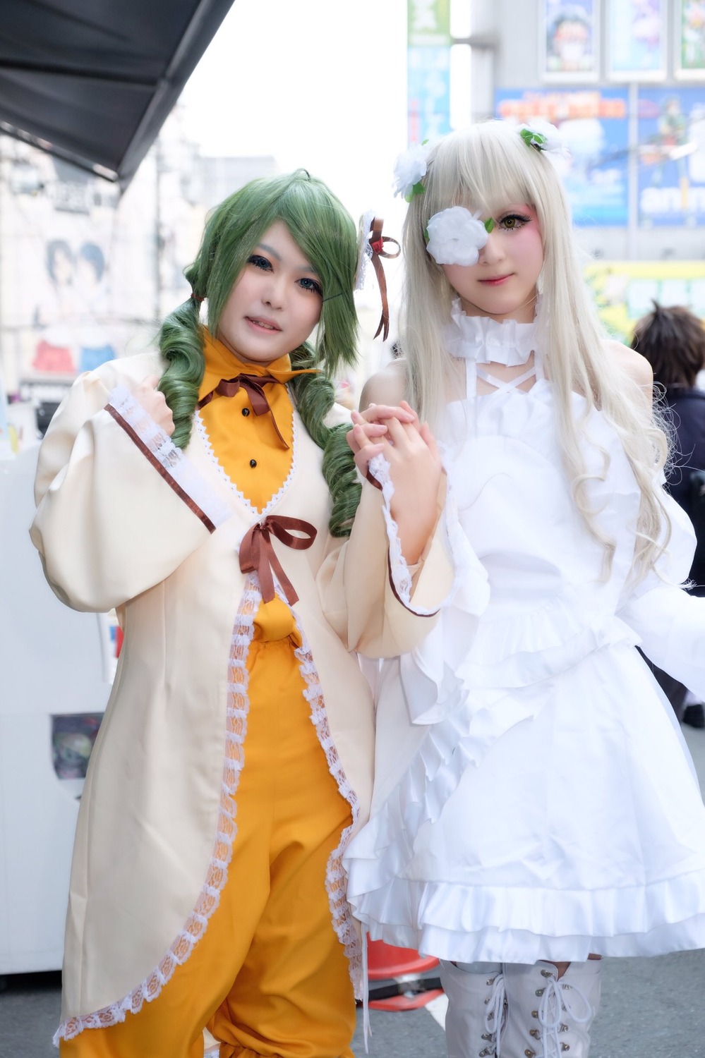 2girls blurry blurry_background blurry_foreground depth_of_field dress frills green_eyes green_hair hair_ornament lips long_hair multiple_cosplay multiple_girls photo standing striped tagme