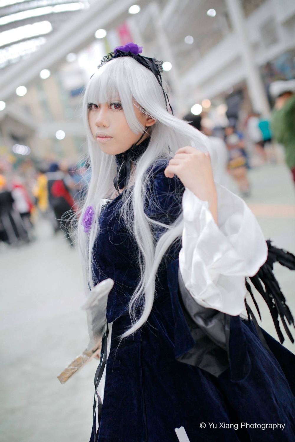 1girl bangs blurry blurry_background blurry_foreground depth_of_field dress hairband long_hair long_sleeves photo red_eyes solo suigintou white_hair