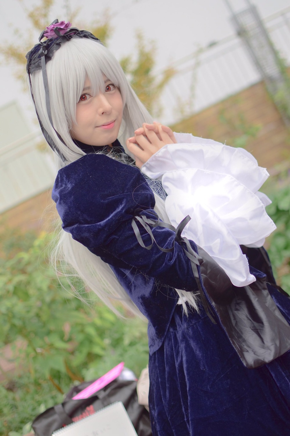 1girl 3d blurry blurry_background blurry_foreground closed_mouth depth_of_field dress hairband lips long_hair long_sleeves looking_at_viewer photo red_eyes solo suigintou