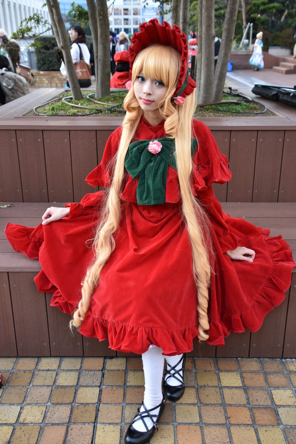 1girl blonde_hair blue_eyes bonnet capelet dress long_hair looking_at_viewer pantyhose pavement photo red_capelet red_dress shinku shoes smile solo standing tile_floor tiles white_legwear