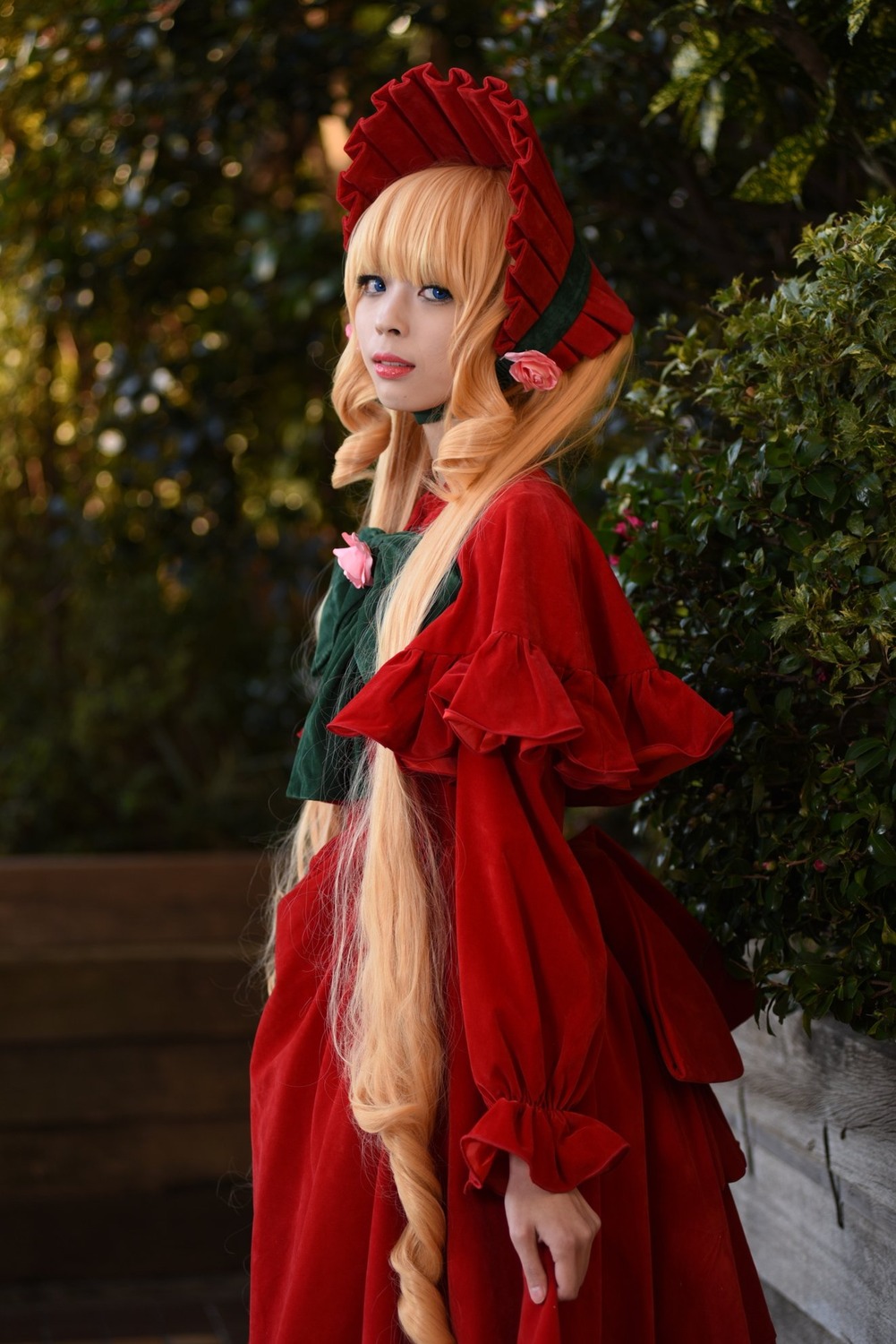 1girl blonde_hair blue_eyes bonnet capelet dress flower lips long_hair looking_at_viewer outdoors realistic red_dress shinku solo standing