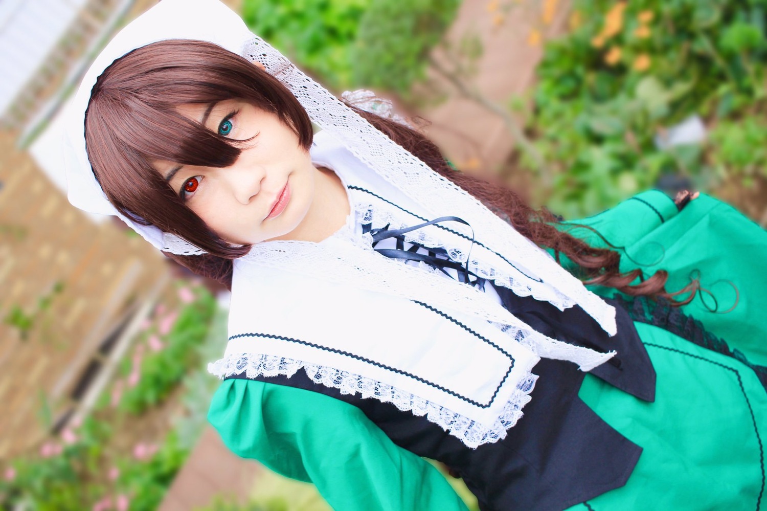 1girl 3d blue_eyes blurry blurry_background blurry_foreground brown_hair depth_of_field dress heterochromia lips looking_at_viewer outdoors photo red_eyes solo suiseiseki