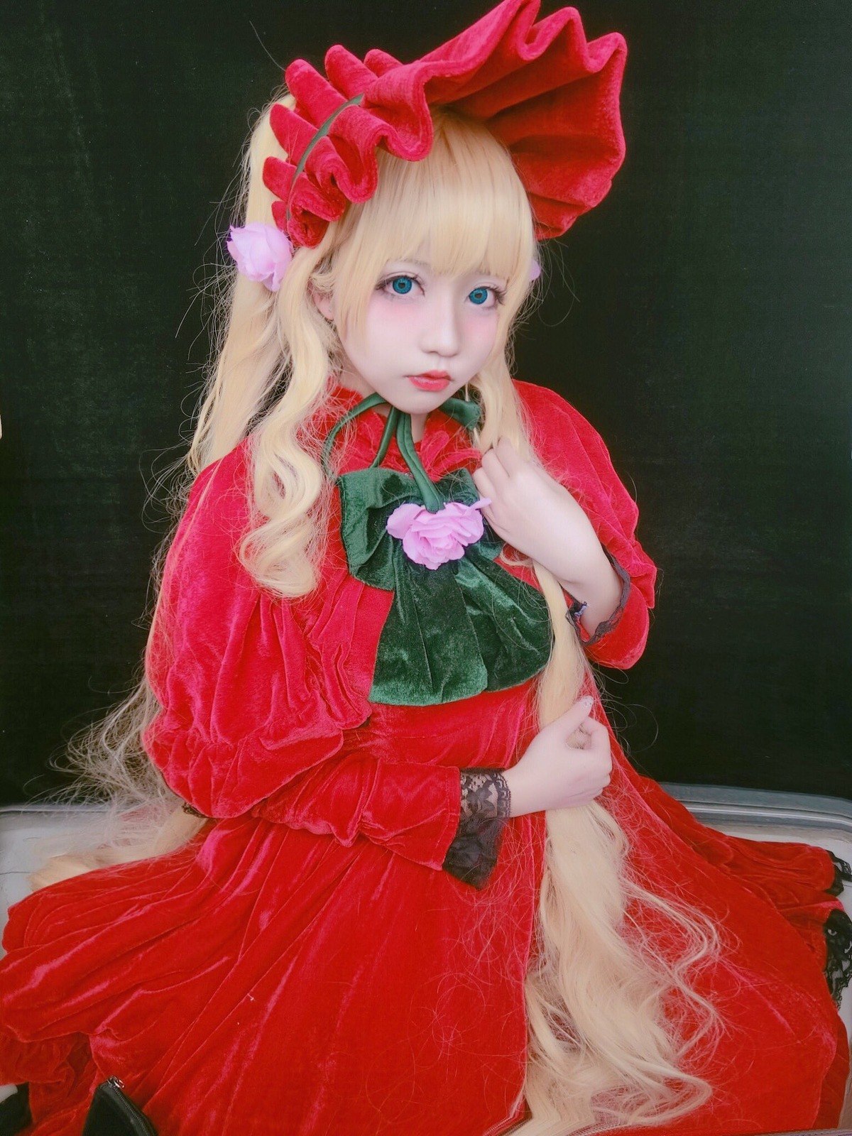 1girl bangs black_background blonde_hair blue_eyes bonnet bow dress flower lips long_hair long_sleeves looking_at_viewer makeup red_capelet red_dress rose shinku solo traditional_media