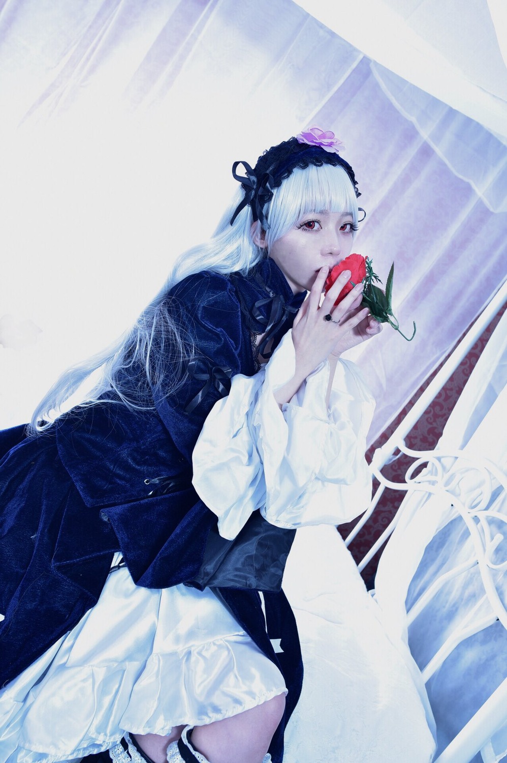 1girl apple dress flower food frills fruit gothic_lolita hairband holding holding_food holding_fruit lolita_fashion long_hair long_sleeves red_eyes solo suigintou