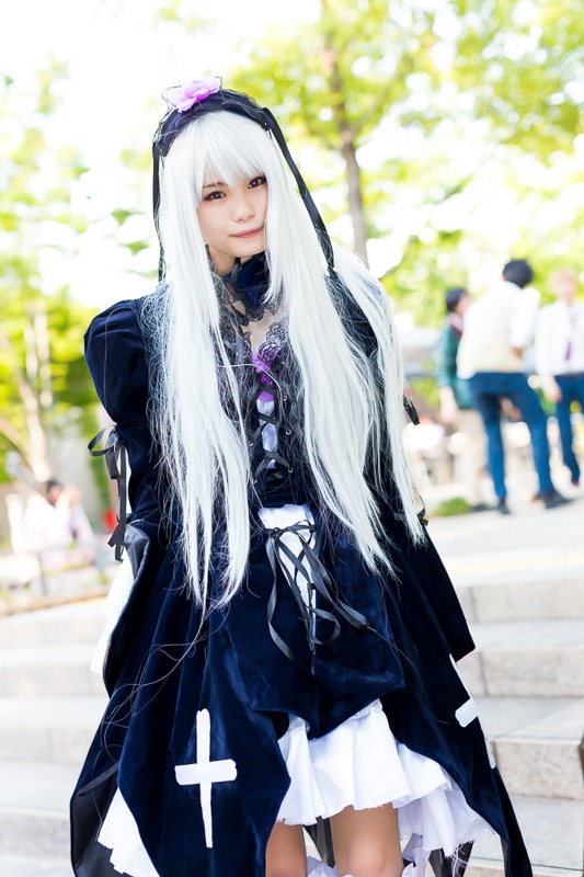 1girl blue_eyes blurry blurry_background blurry_foreground depth_of_field dress frills long_hair long_sleeves looking_at_viewer photo smile solo standing suigintou very_long_hair