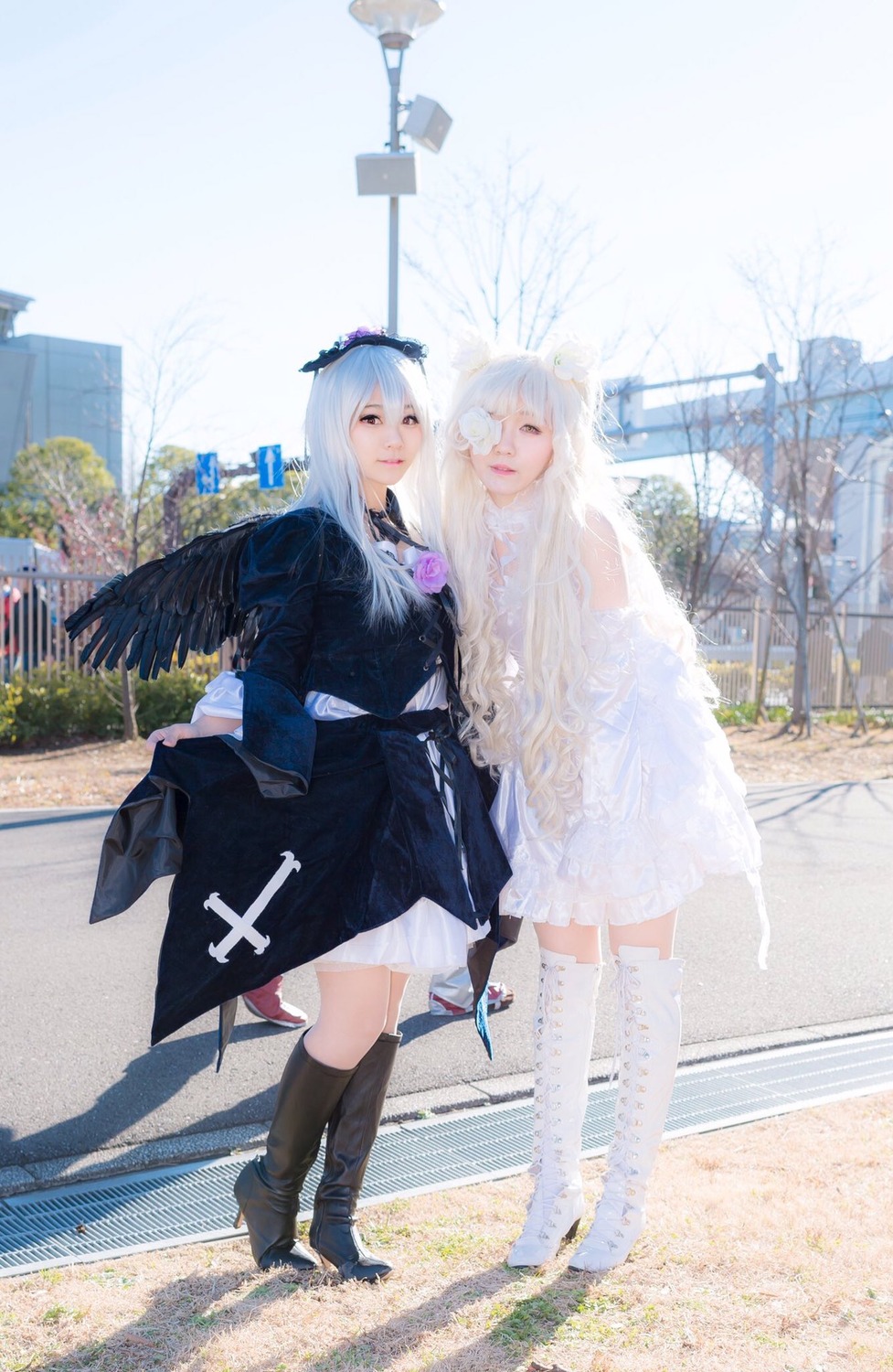 2girls bangs black_dress black_footwear black_gloves black_legwear boots building day dress flower gloves kneehighs long_hair long_sleeves looking_at_viewer multiple_cosplay multiple_girls outdoors standing tagme wings