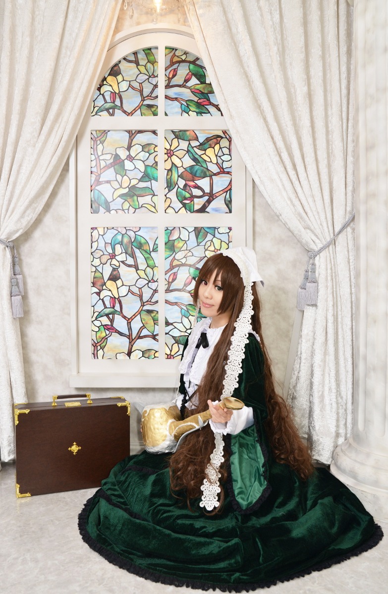 1girl brown_hair curtains dress flower green_dress indoors long_sleeves sitting solo suiseiseki window