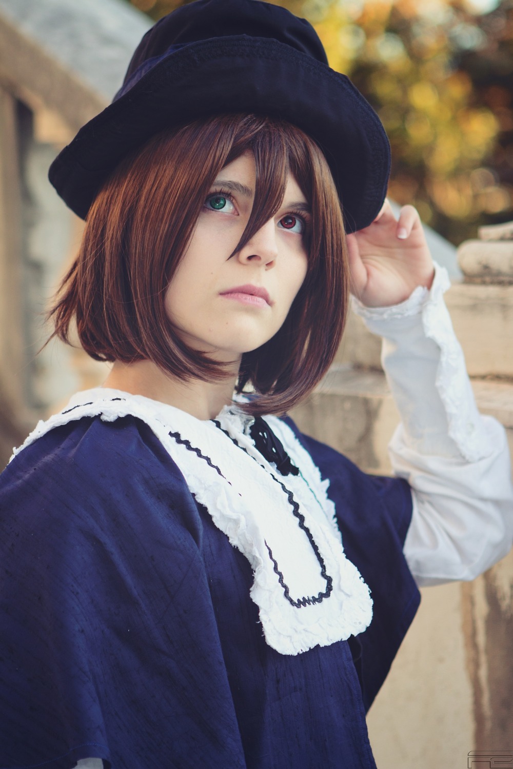 1girl black_headwear blue_dress blurry blurry_background brown_hair closed_mouth depth_of_field dress green_eyes hair_between_eyes hat lips long_sleeves looking_at_viewer outdoors short_hair solo souseiseki upper_body