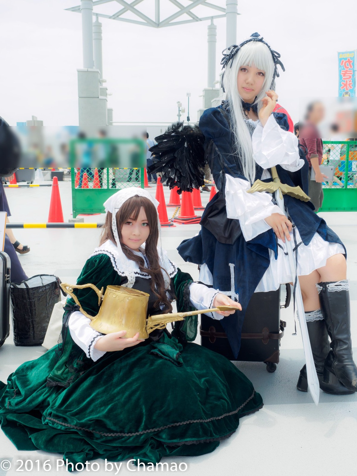 2girls blurry blurry_background blurry_foreground boots braid brown_hair depth_of_field dress long_hair looking_at_viewer multiple_cosplay multiple_girls sitting tagme