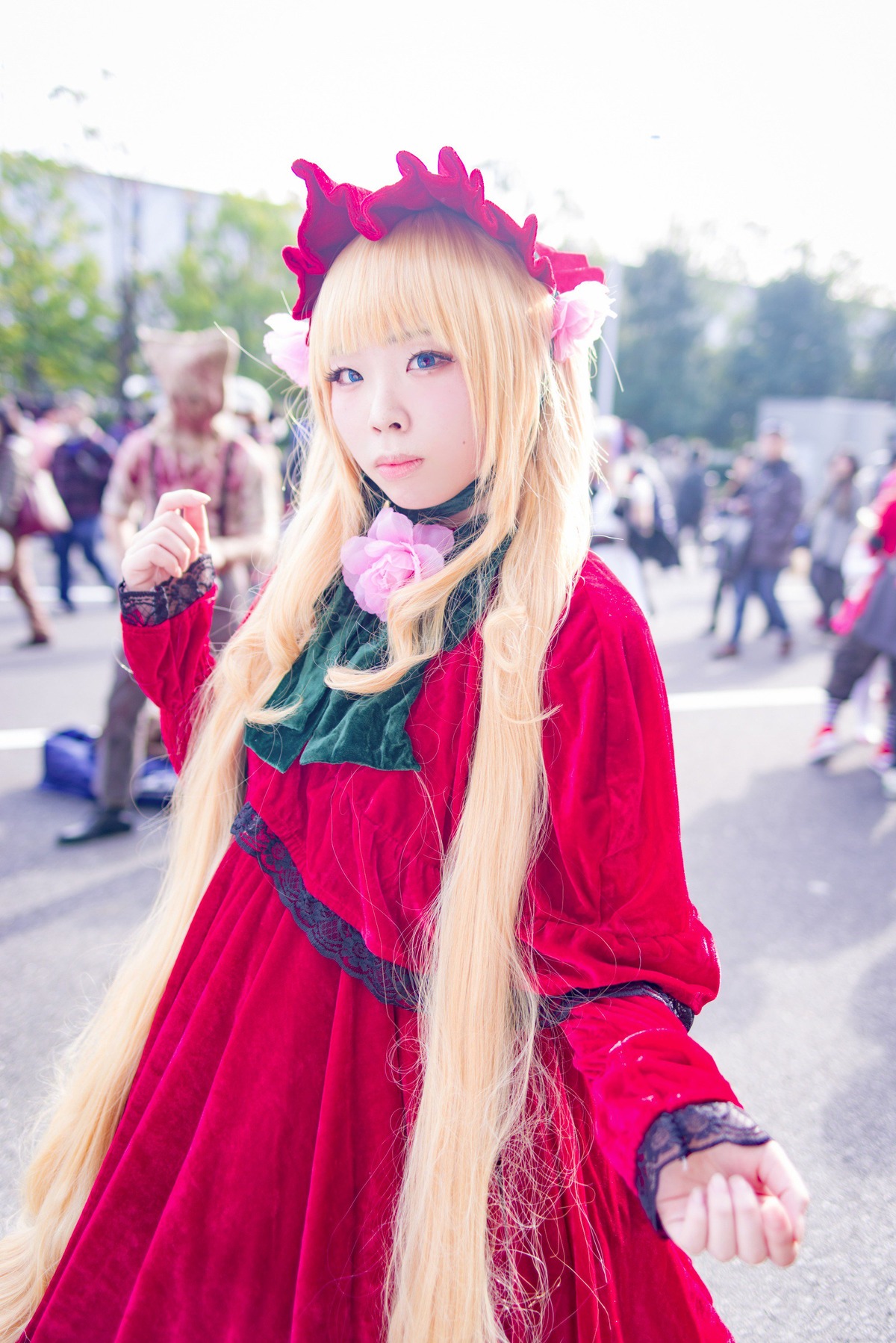 1girl bangs blonde_hair blue_eyes blurry blurry_background depth_of_field dress long_hair long_sleeves looking_at_viewer outdoors photo red_dress shinku solo