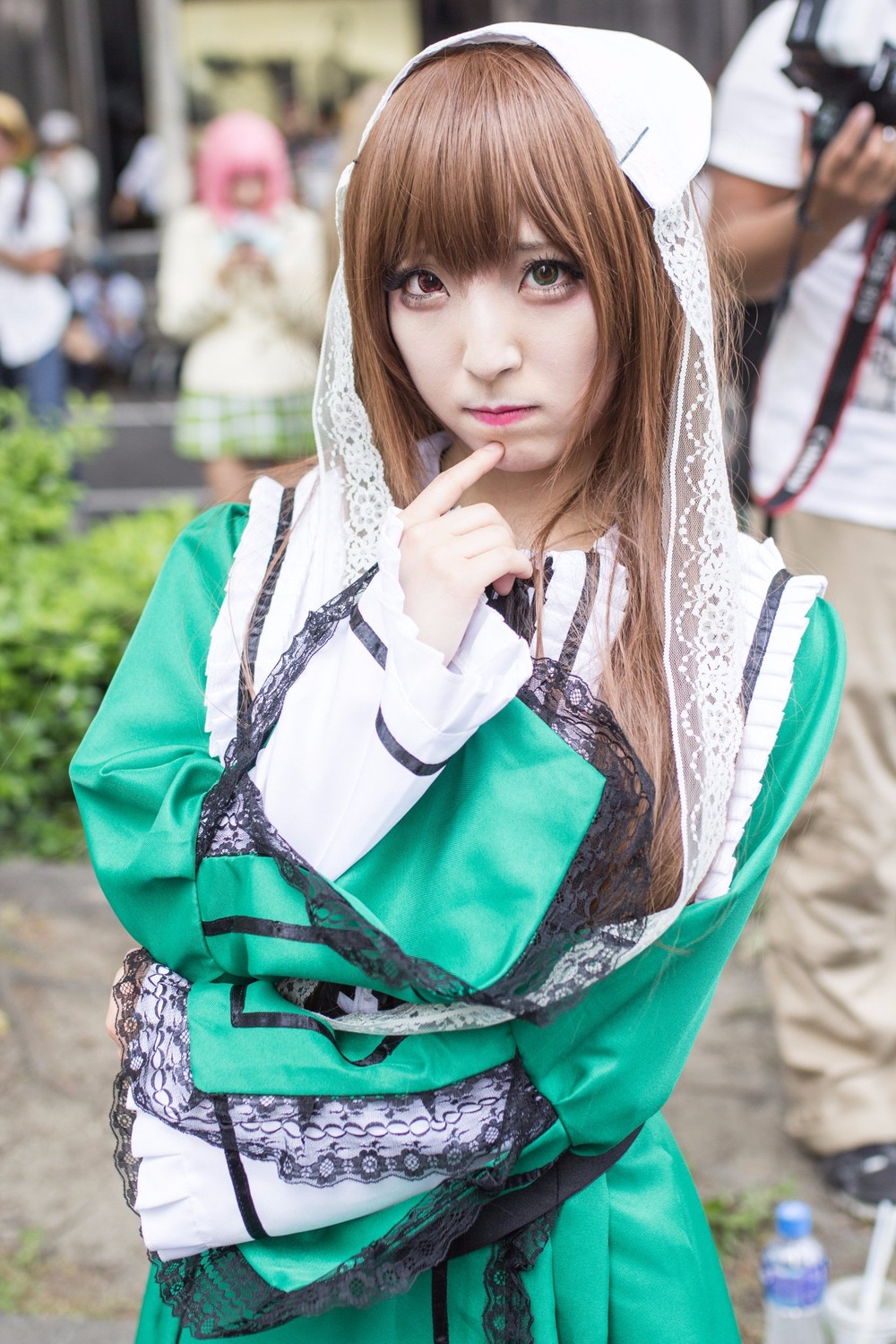 1girl 3d bangs blurry blurry_background blurry_foreground brown_hair chain chromatic_aberration depth_of_field dress figure green_dress lace lips long_hair long_sleeves looking_at_viewer motion_blur photo solo suiseiseki