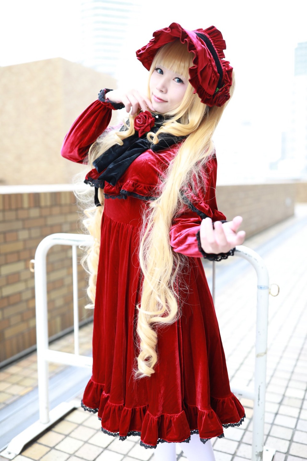 1girl blonde_hair blue_eyes blurry depth_of_field dress flower long_hair long_sleeves looking_at_viewer red_dress rose shinku solo standing