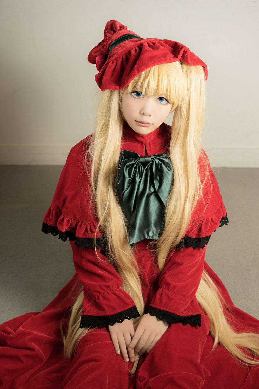 1girl blonde_hair blue_eyes bow capelet dress long_hair long_sleeves looking_at_viewer red_capelet red_dress shinku sitting solo v_arms very_long_hair