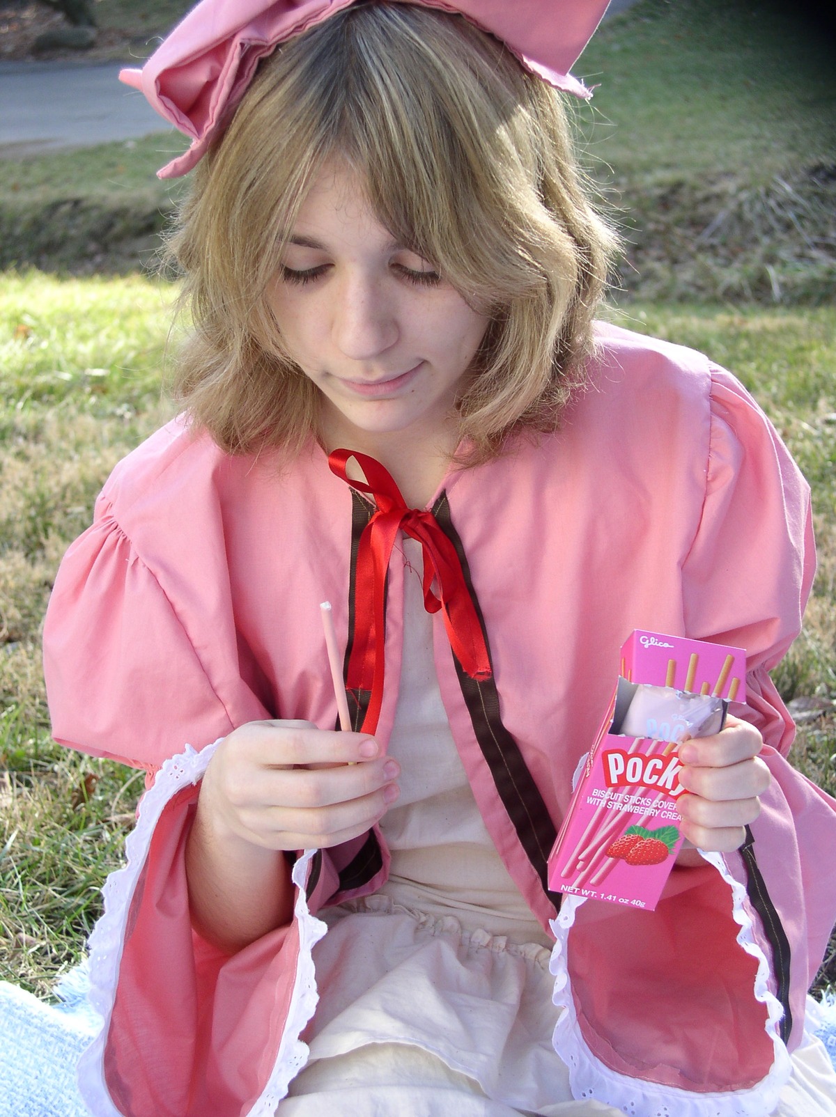 1girl blonde_hair bow closed_eyes day dress grass hinaichigo lips long_sleeves outdoors pink_dress realistic ribbon short_hair smile solo