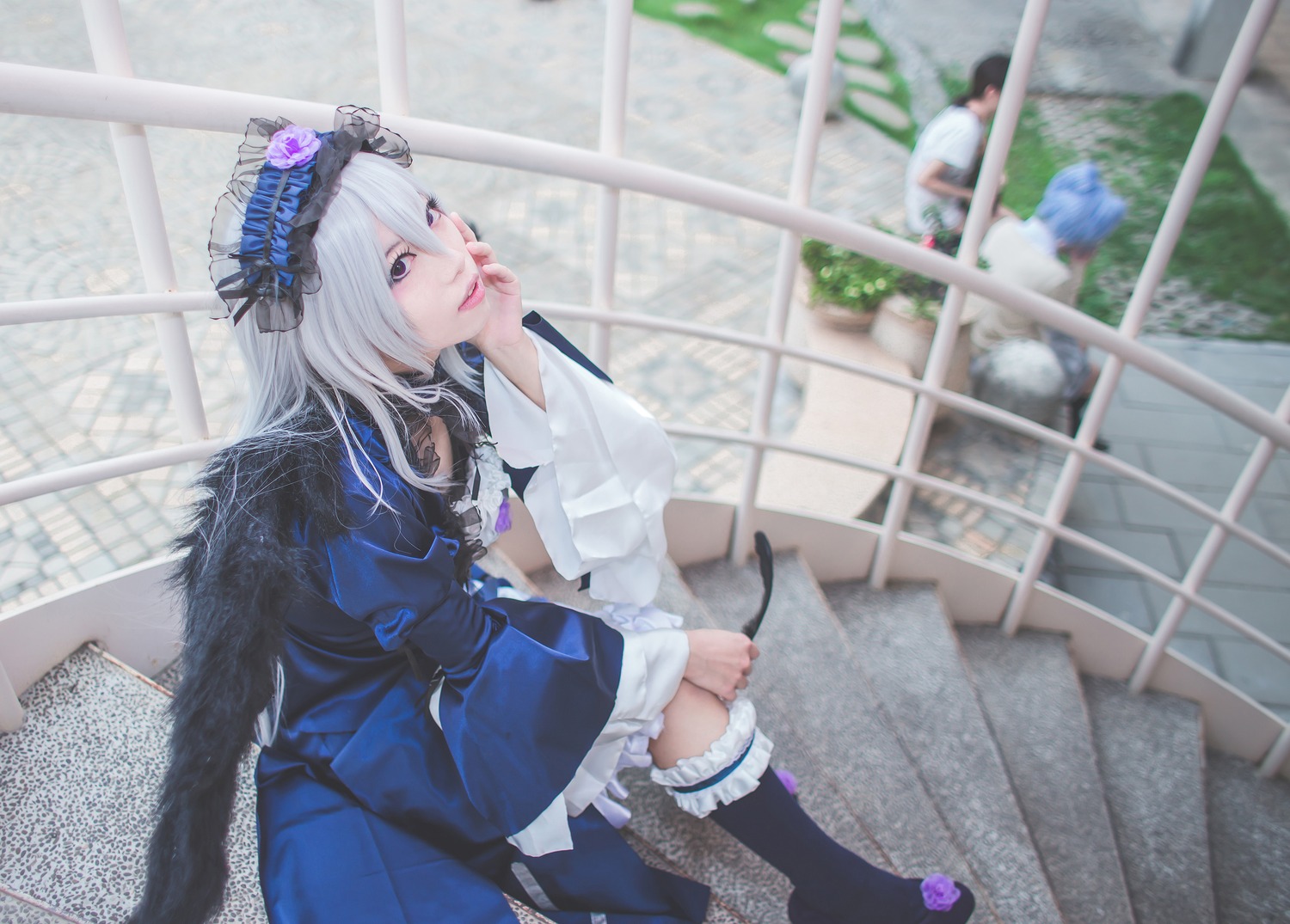 1girl black_legwear blurry depth_of_field dress frills kneehighs lolita_fashion long_hair sitting solo suigintou