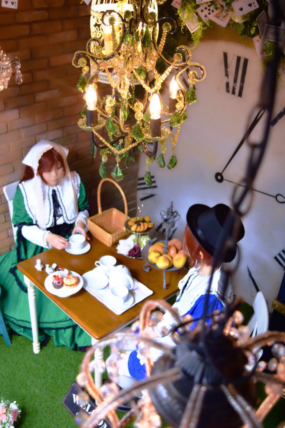 1boy 1girl apron blurry blurry_background blurry_foreground brown_hair cup depth_of_field food fruit hat indoors multiple_cosplay plate sitting table tagme teacup