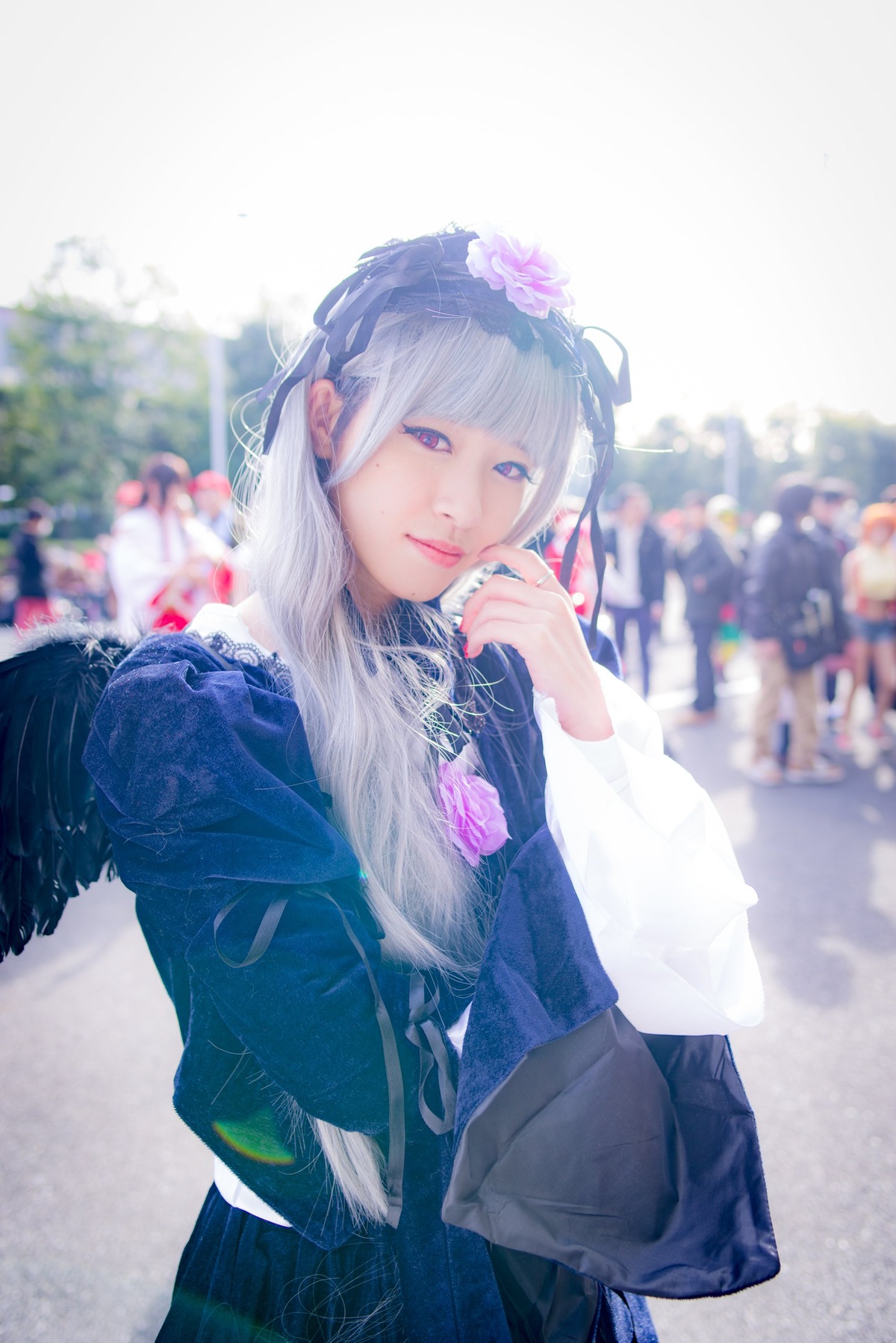 1girl bag bangs blunt_bangs blurry blurry_background closed_mouth depth_of_field flower hair_flower hair_ornament lips long_hair looking_at_viewer outdoors purple_eyes solo suigintou