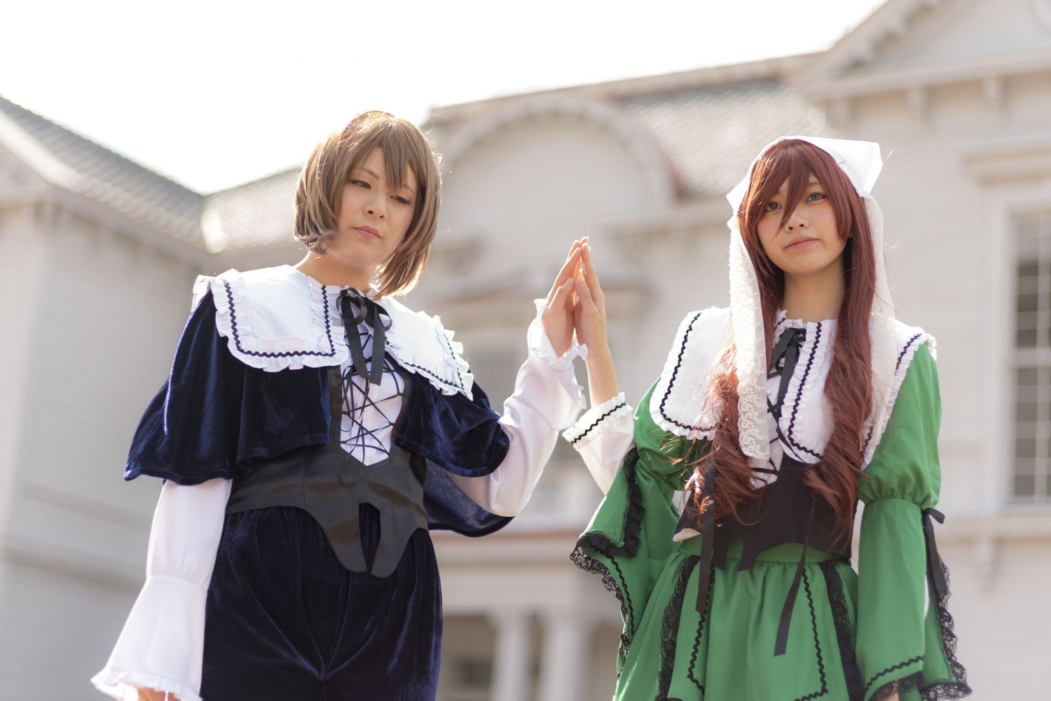 2girls blurry blurry_background brown_hair capelet closed_eyes depth_of_field dress green_dress green_eyes long_hair multiple_cosplay multiple_girls ribbon tagme