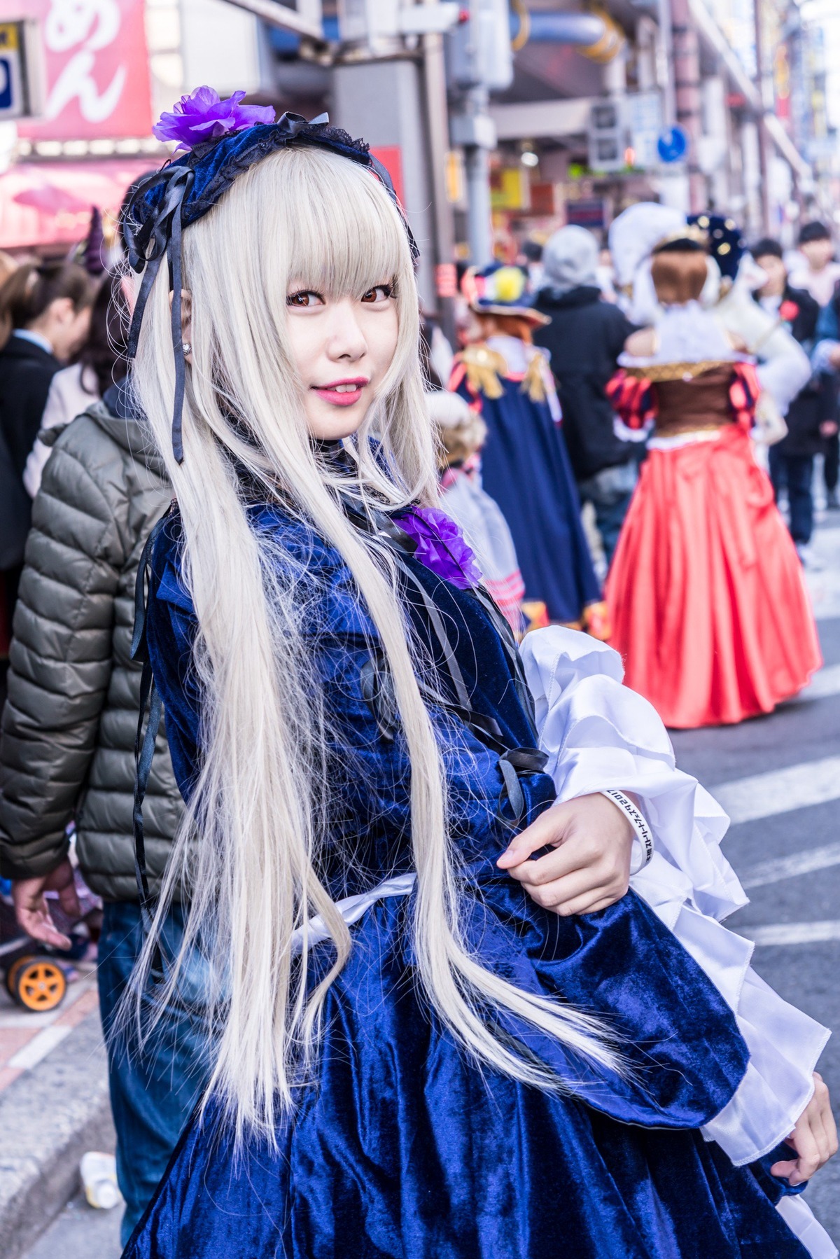 1girl bangs blurry blurry_background blurry_foreground depth_of_field dress hairband indoors long_hair long_sleeves looking_at_viewer photo solo solo_focus suigintou