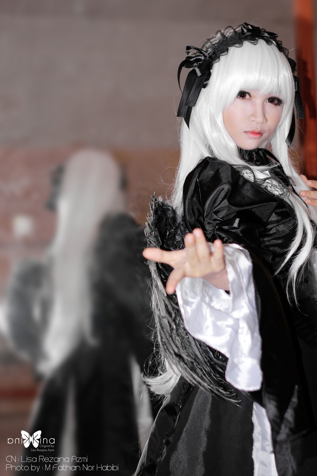 1girl 3d black_dress blurry blurry_background blurry_foreground depth_of_field dress frills gothic_lolita hairband lips lolita_fashion long_hair long_sleeves looking_at_viewer photo solo suigintou very_long_hair