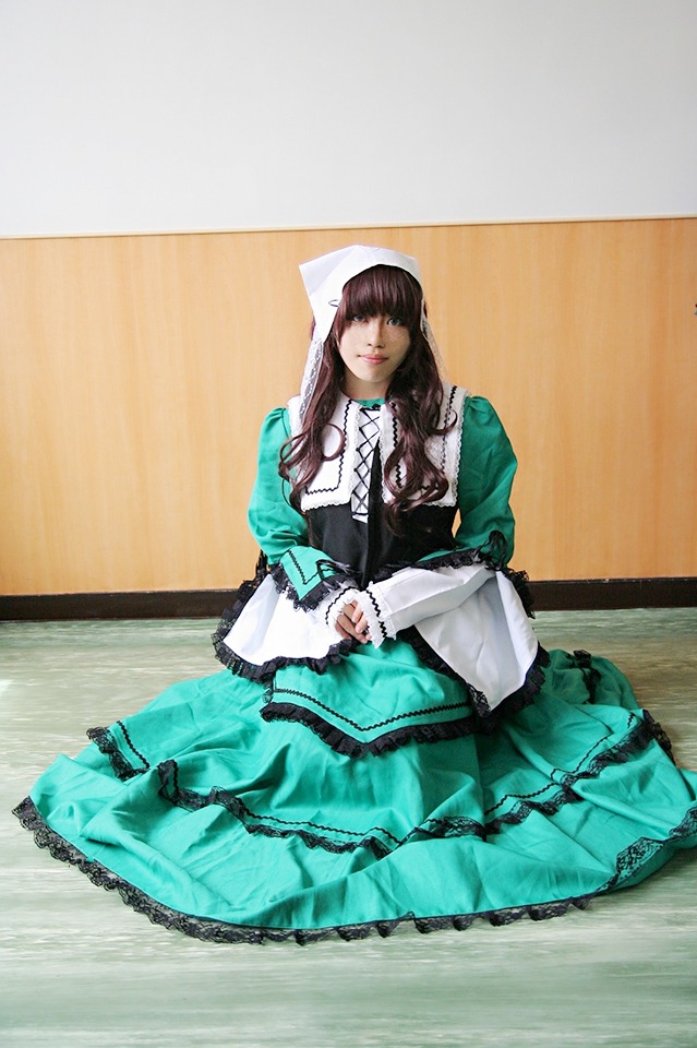 1girl bangs brown_hair dress frills green_dress long_hair long_sleeves sitting solo suiseiseki