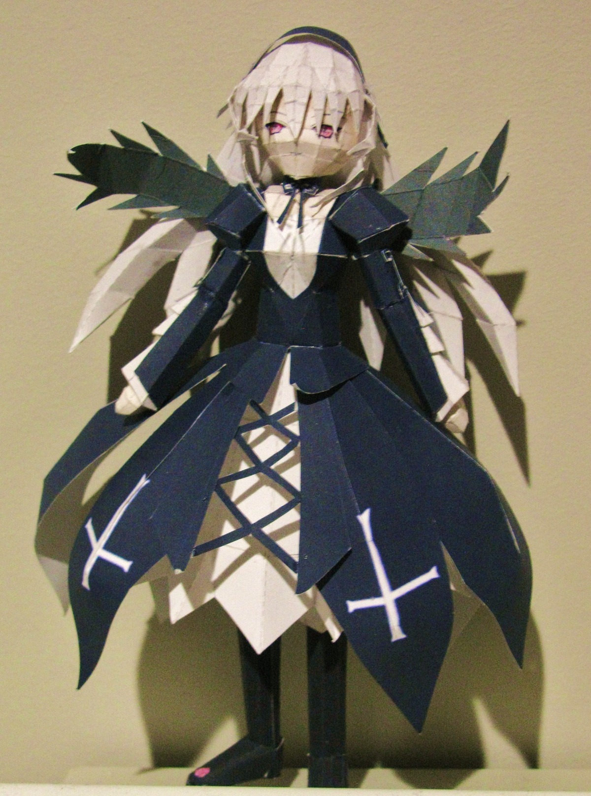 1girl doll dress long_sleeves looking_at_viewer red_eyes solo standing suigintou white_hair wings