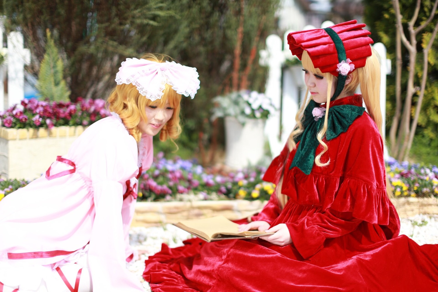 2girls blonde_hair blurry blurry_background blurry_foreground bonnet closed_eyes depth_of_field dress food hat long_hair multiple_cosplay multiple_girls outdoors sitting table tagme