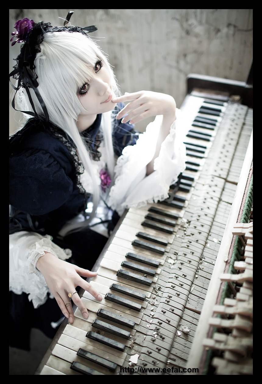 1girl black_border black_nails dress frills gothic_lolita instrument jewelry keyboard_(instrument) letterboxed lips lolita_fashion long_sleeves music nail_polish piano playing_instrument ring silver_hair solo suigintou white_hair wings