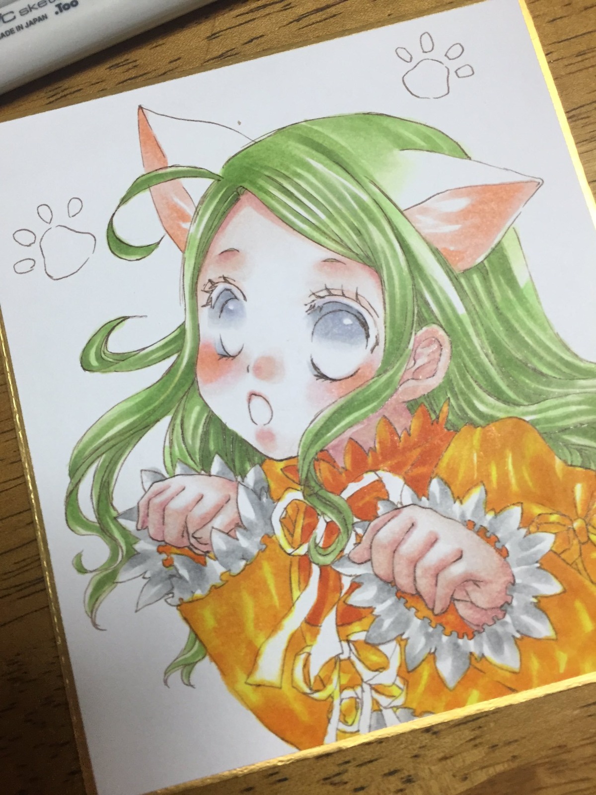 1girl :o ahoge animal_ears blue_eyes blush cat_ears green_hair image kanaria long_sleeves looking_at_viewer marker_(medium) photo shikishi solo table traditional_media upper_body