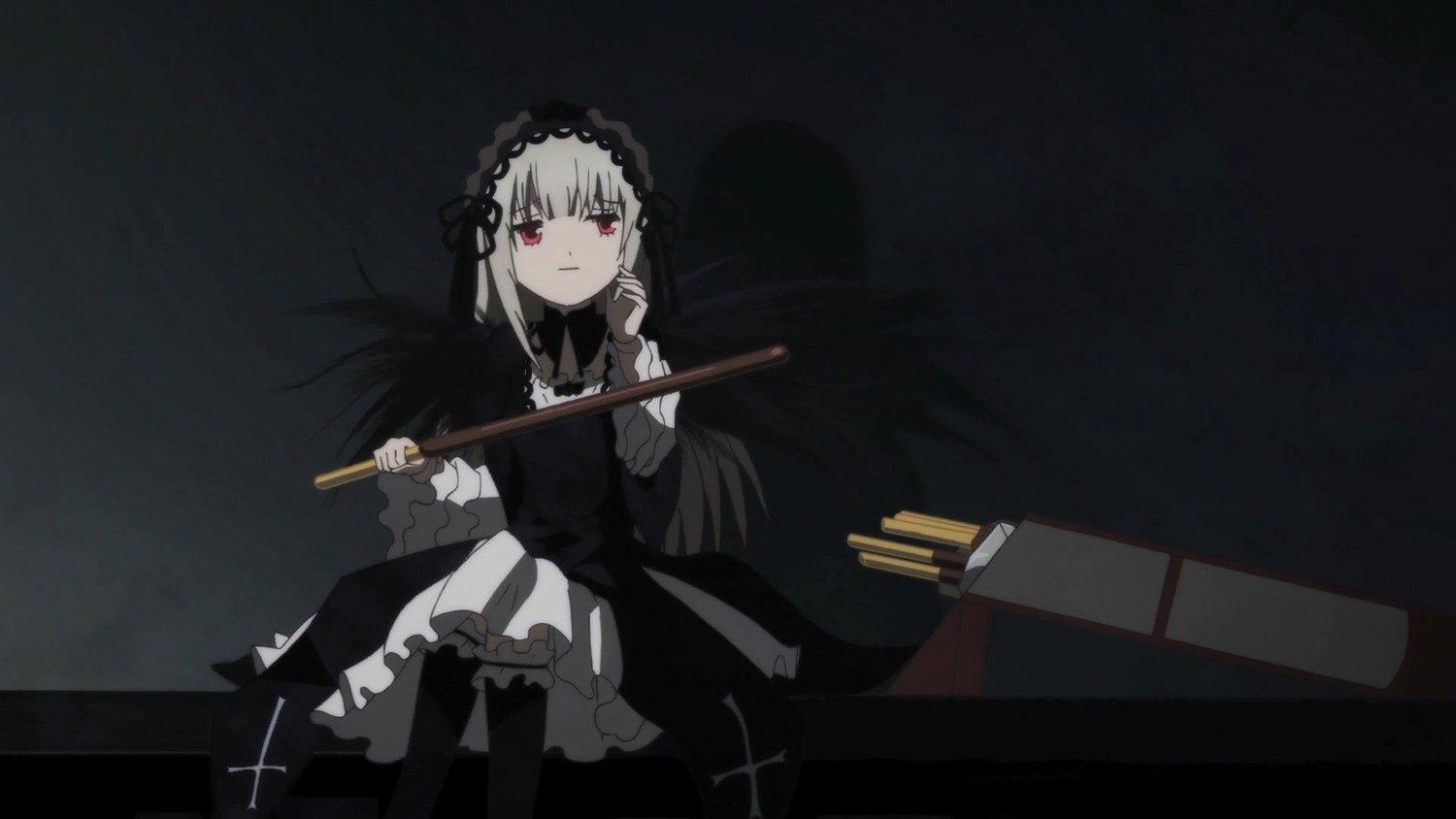 1girl auto_tagged black_background black_dress dress frills gothic_lolita hairband holding image lolita_fashion long_hair long_sleeves looking_at_viewer red_eyes sitting solo suigintou