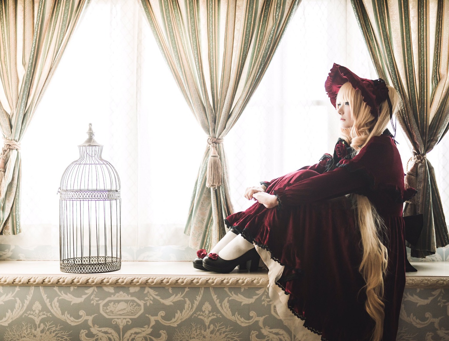 1girl birdcage blonde_hair bonnet cage curtains doll dress indoors long_sleeves red_dress shinku shoes solo sunlight window
