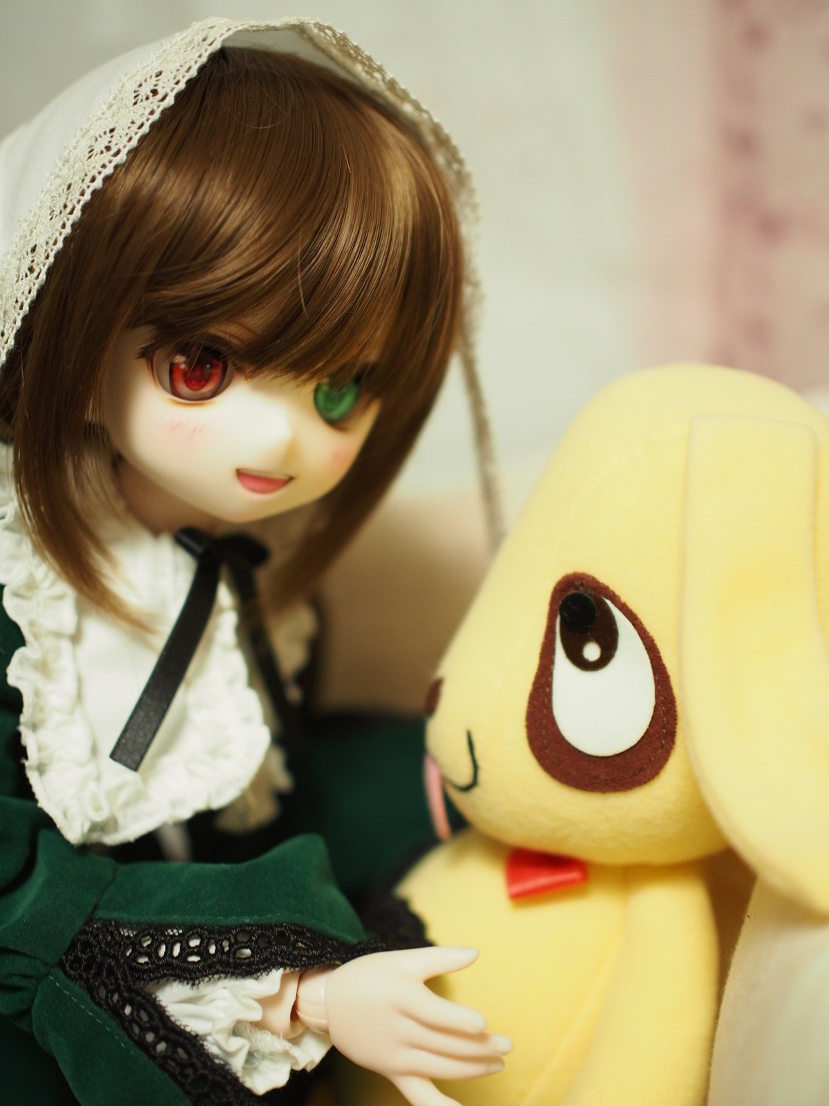 :d blurry brown_hair doll dress frills heterochromia long_sleeves looking_at_viewer open_mouth photo red_eyes smile solo suiseiseki